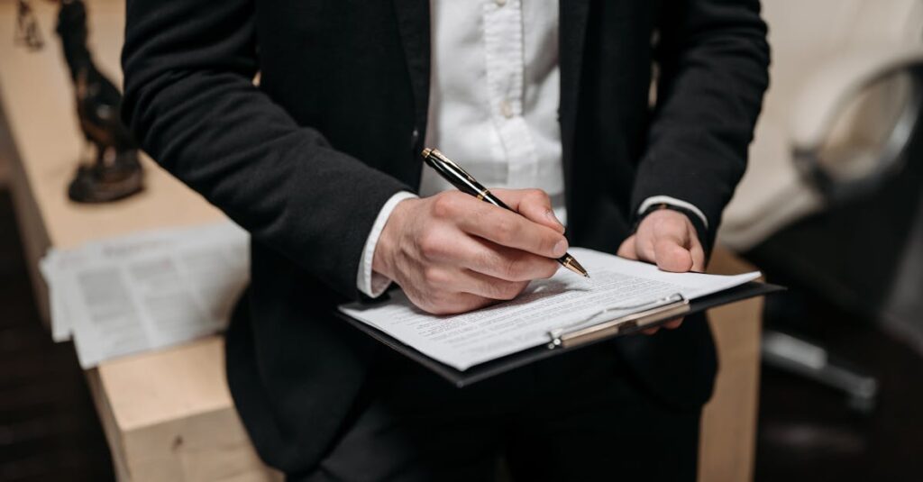 Business professional signing a contract on a clipboard at the office.